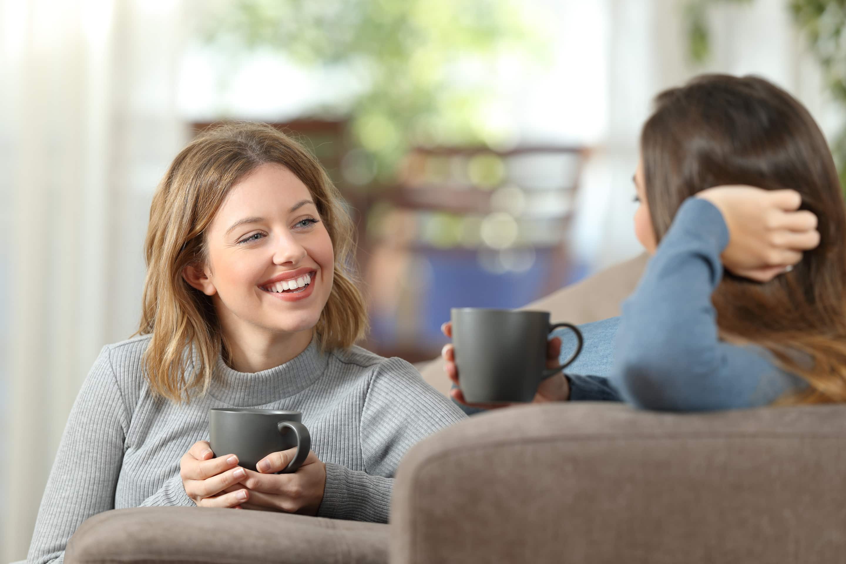 Two Friends Having A Casual Conversation At Home