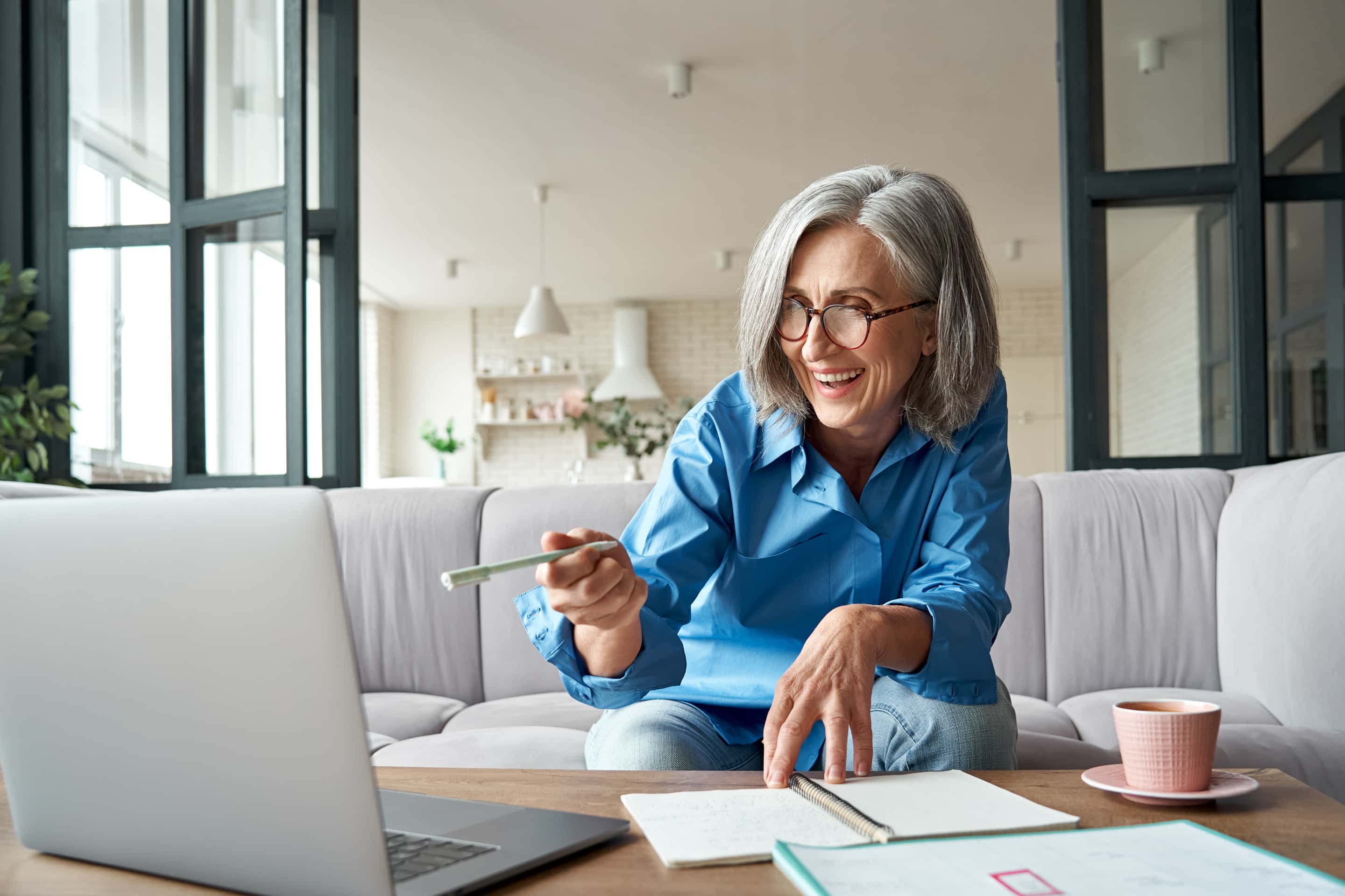 Happy Mature Older Woman Video Calling On Laptop Working From Home