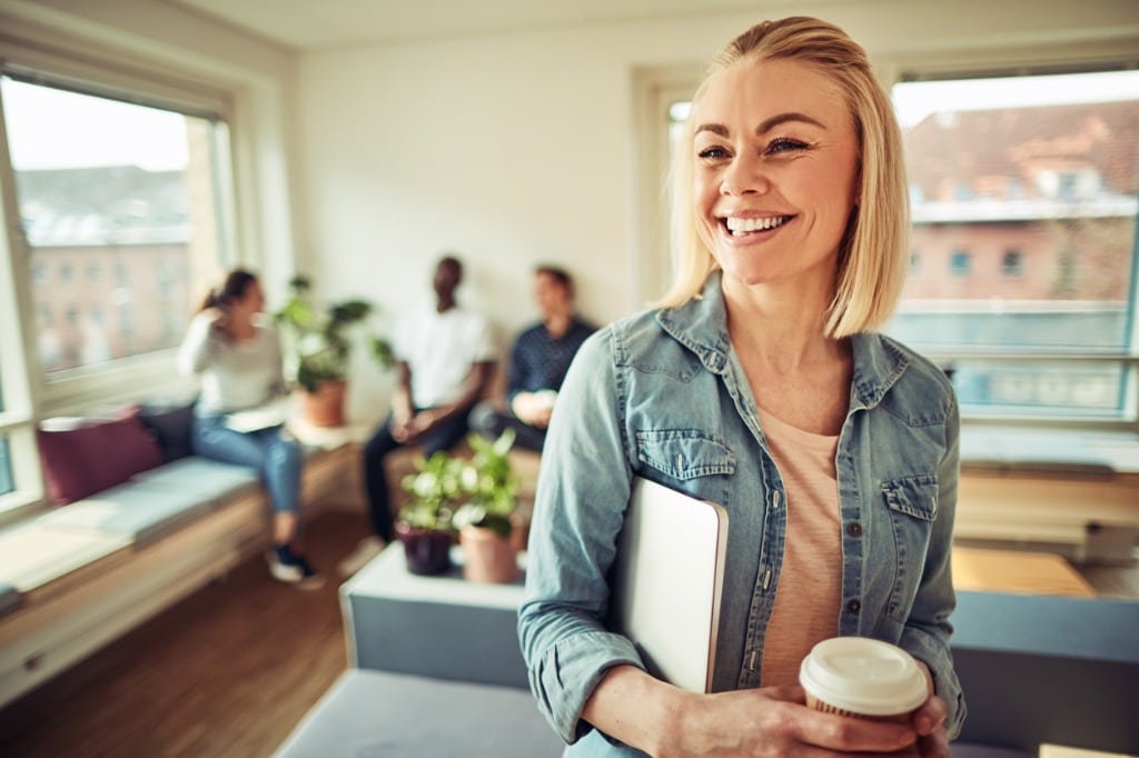 Laughing Young Businesswoman Drinking Coffee During Her Office Break Picture Id961431904