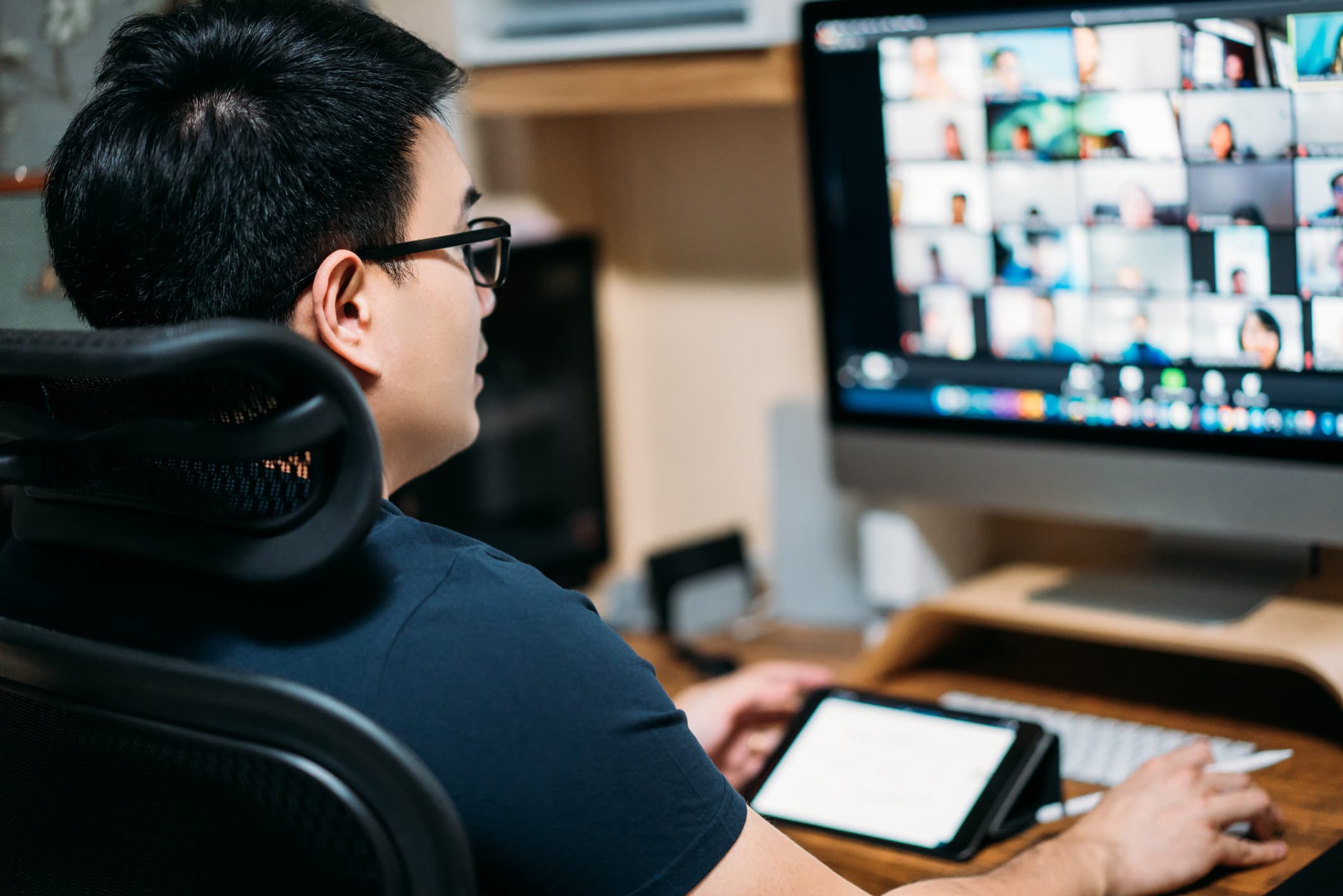 Young Asian Business Man Using Computer For A Online Business Meeting With His Colleagues About Plan In Video Conference Back View Of Business Man Have Webcam Group Conference With Coworkers At Home